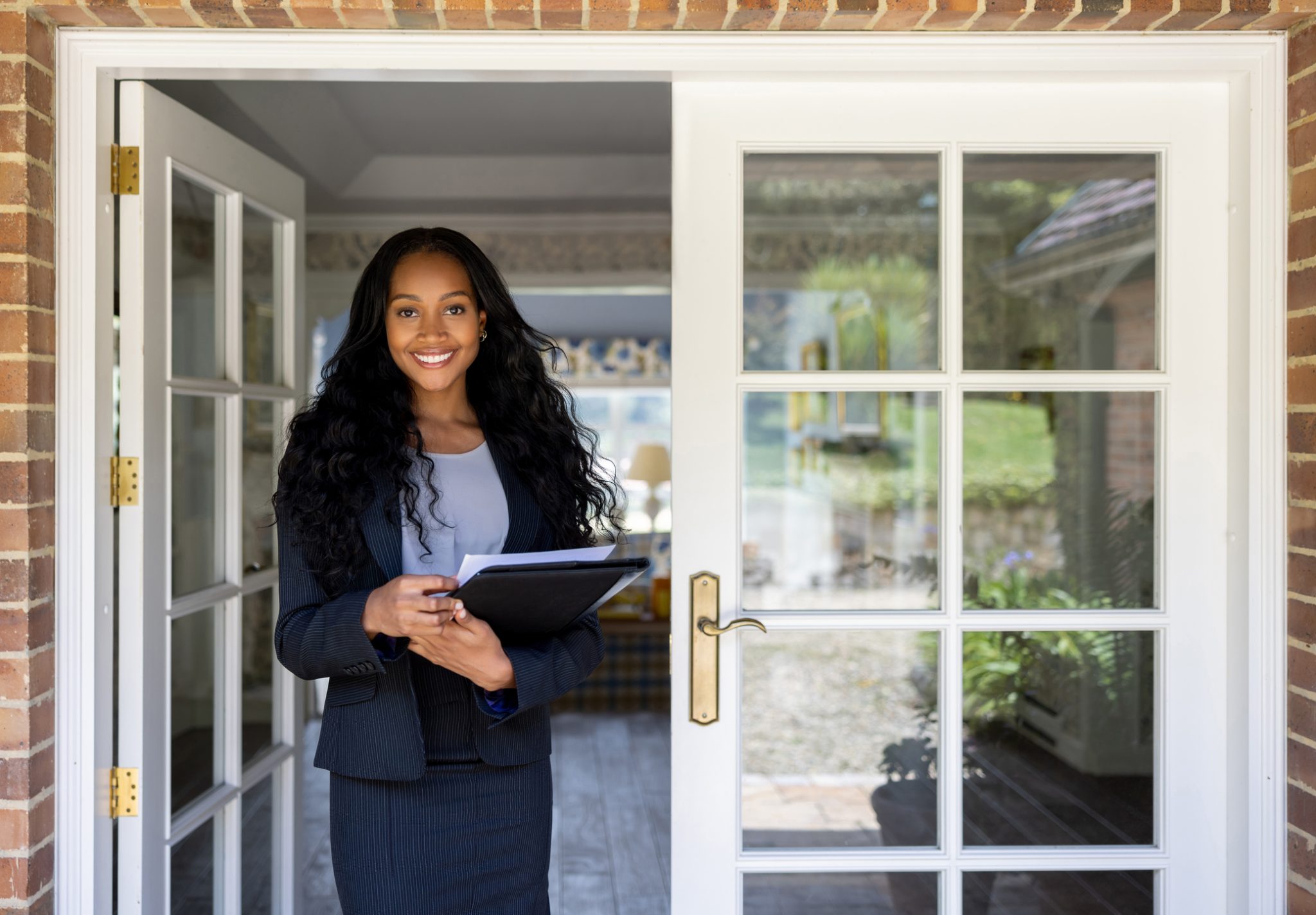 Female real estate agent standing in the doorway of a home