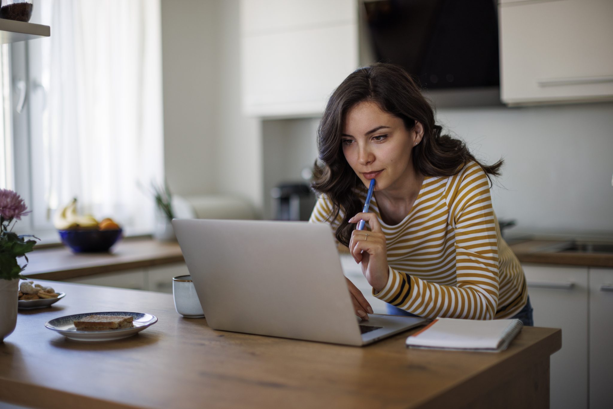 Woman doing online real estate school in Covington home