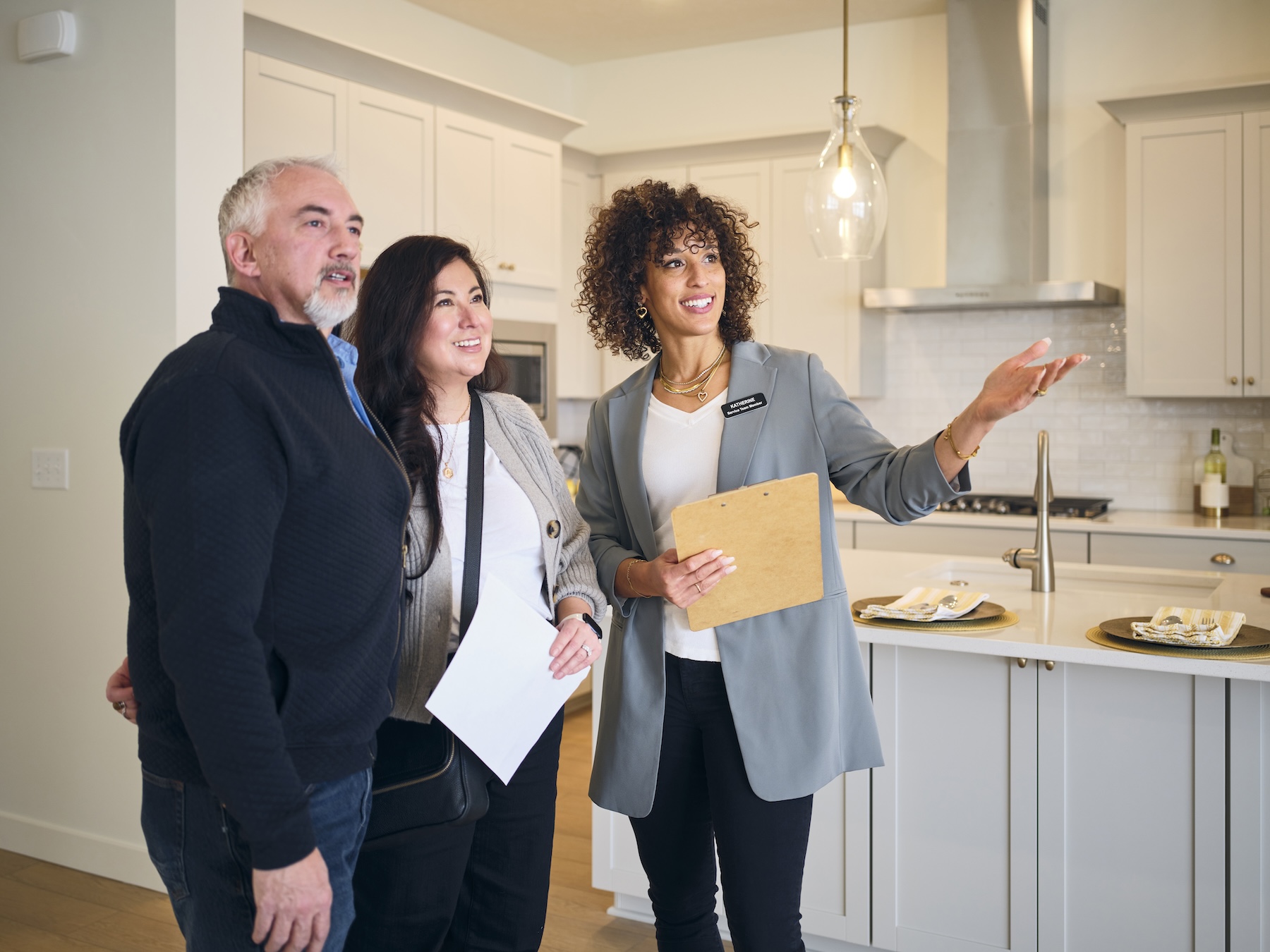 Real estate agents showing a new home to couple